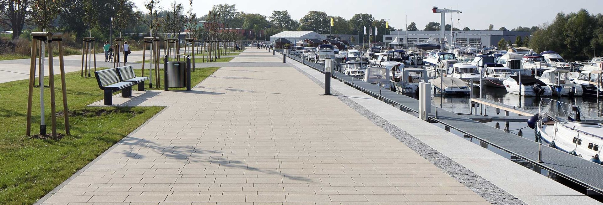 Großzügige Promenade mit Via Tagona Pflasterbelag entlang einer Marina